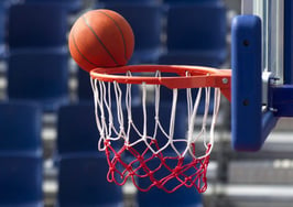 A basketball just missing the basket